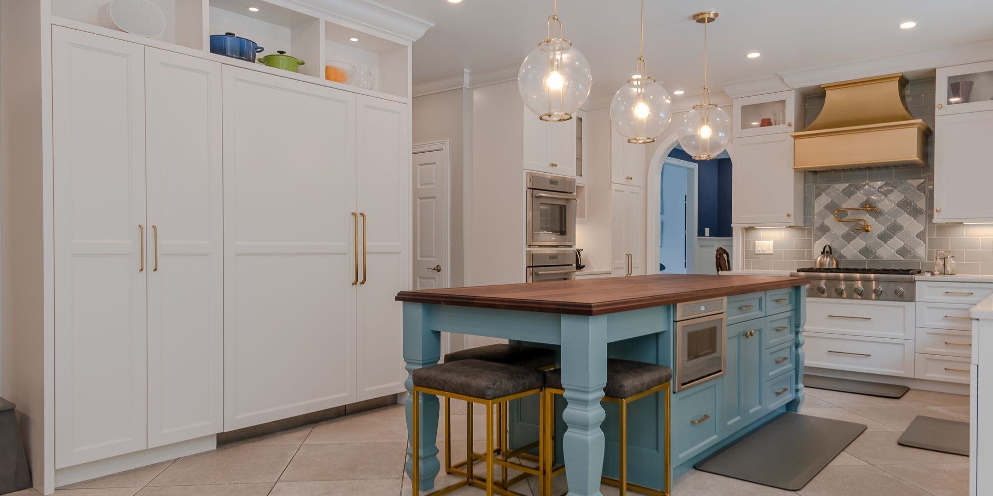 Kitchen remodel with blue island and white cabinets