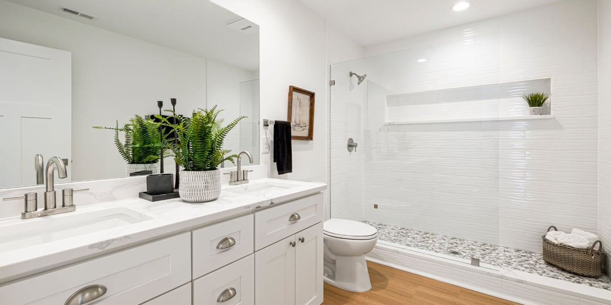 bathroom remodel in ohio with white double sink vanity and frameless glass shower